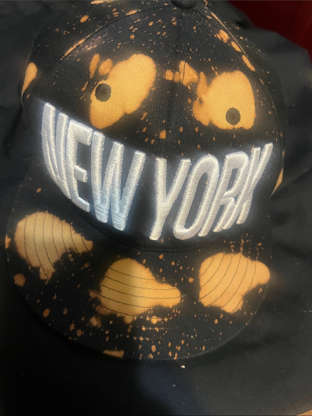 Carbon Black Hat with Orange Bleach Splatter "NEW YORK" Embroidery